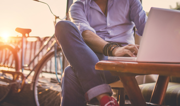 man sitting outside on his laptop